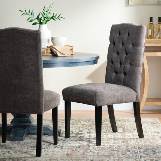 Tufted charcoal grey dining chair with dark wood legs accentuating elegant home decor
