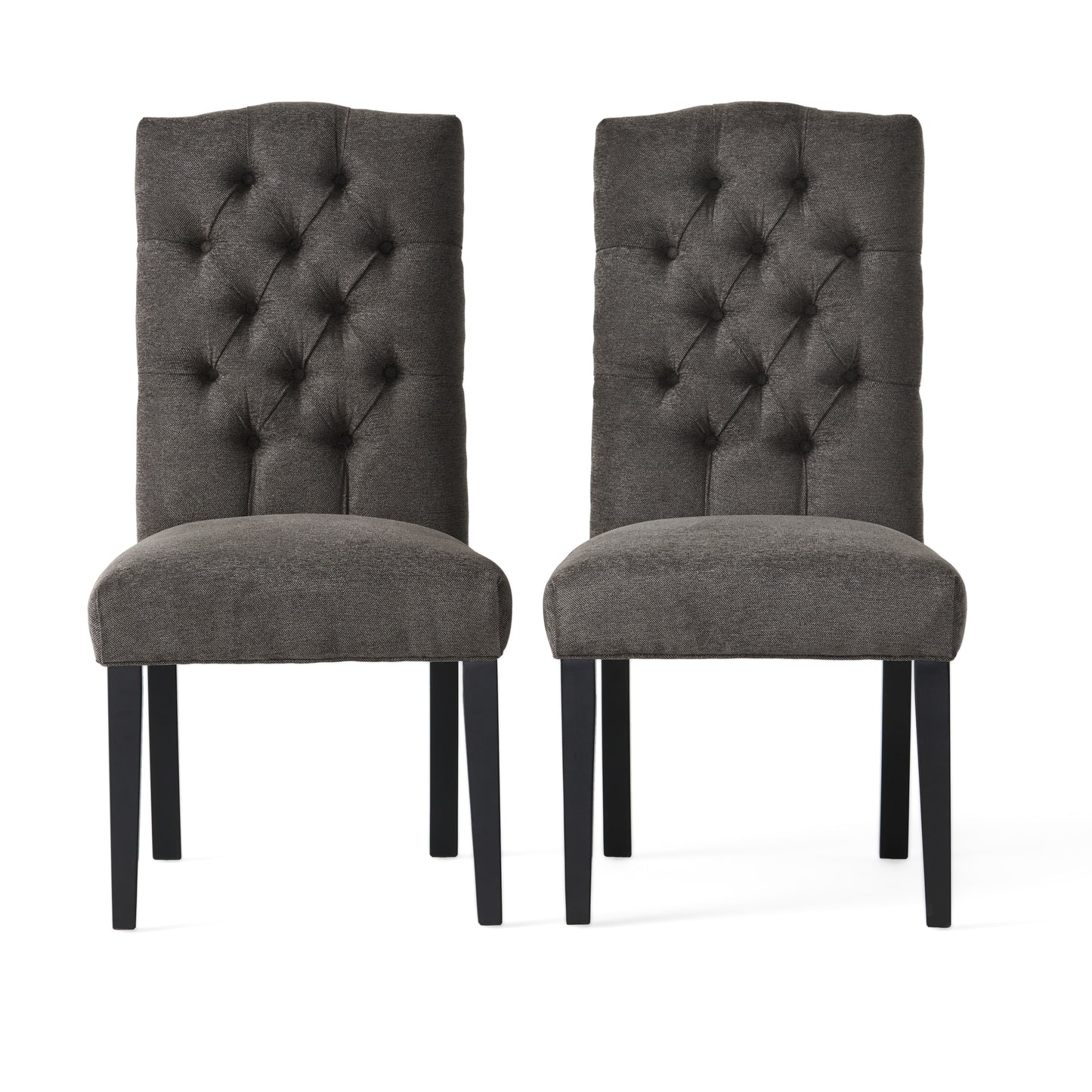 Two dark grey upholstered dining chairs with tufted backs and black legs