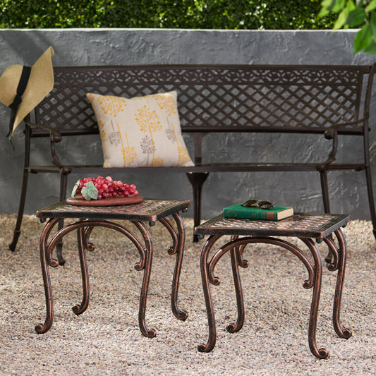 Ornate bronze metal side table with scrolled legs and textured tabletop perfect for outdoor patios