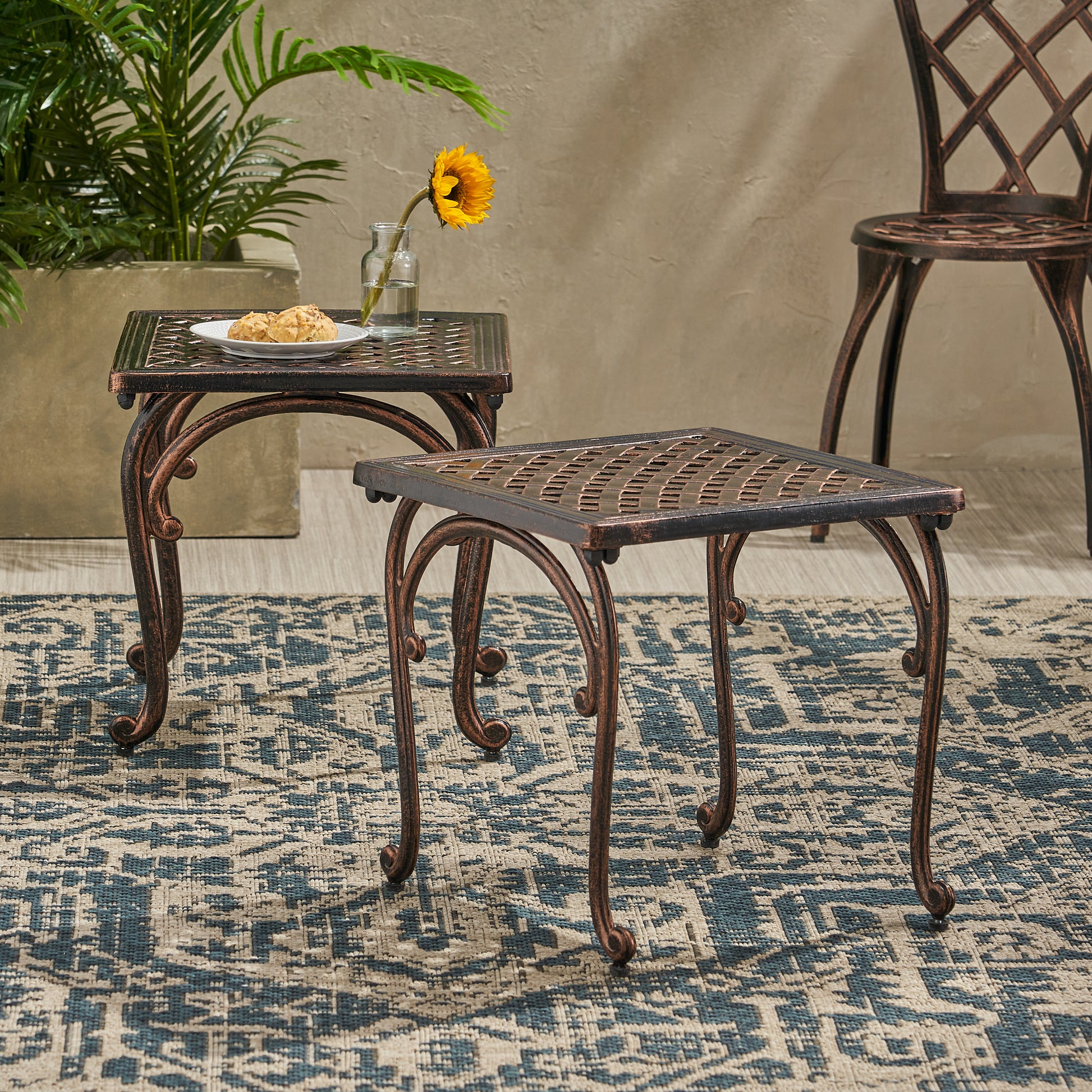 Ornate bronze accent table with woven top and scroll legs