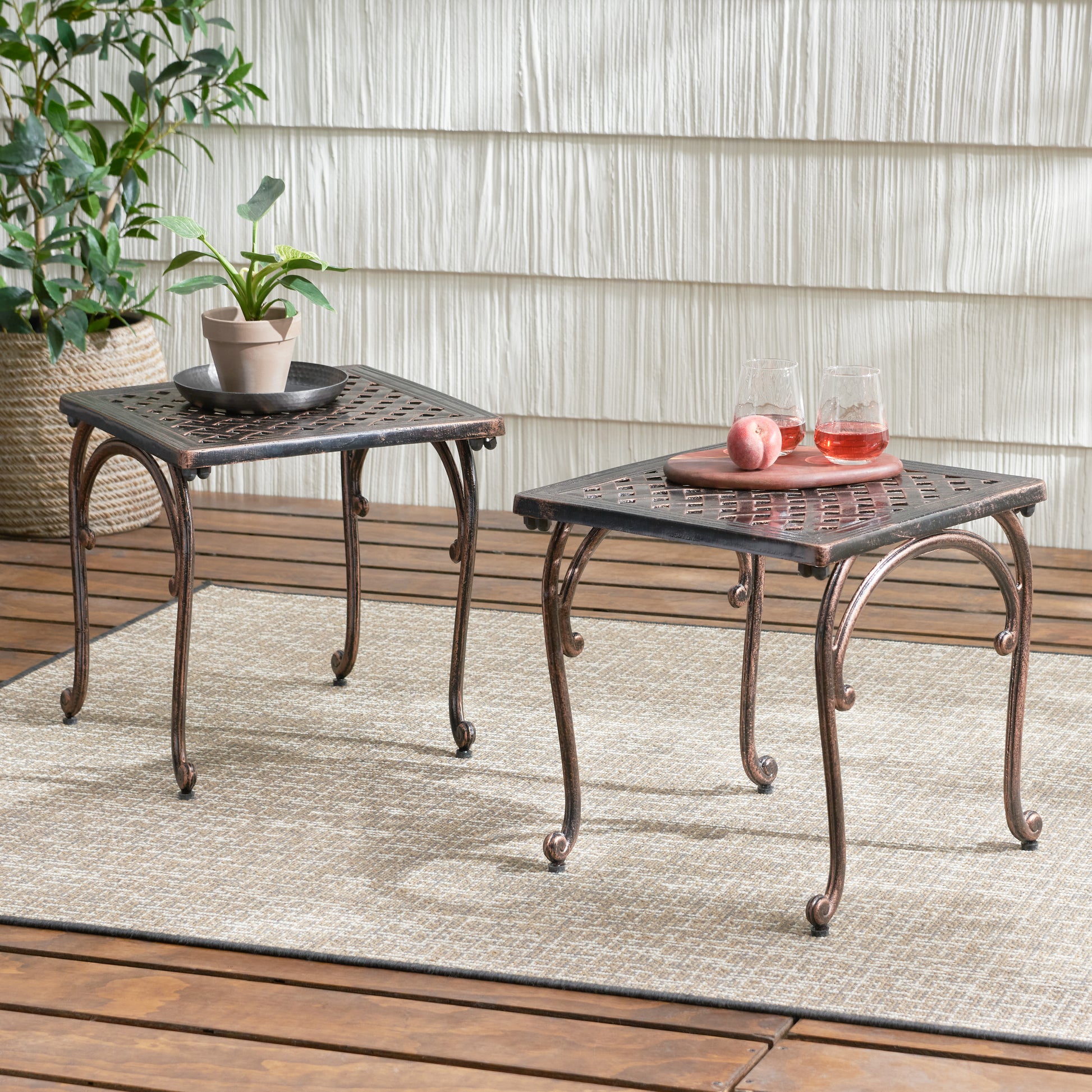 Ornate bronze metal side table with patterned top perfect for outdoor patio decor