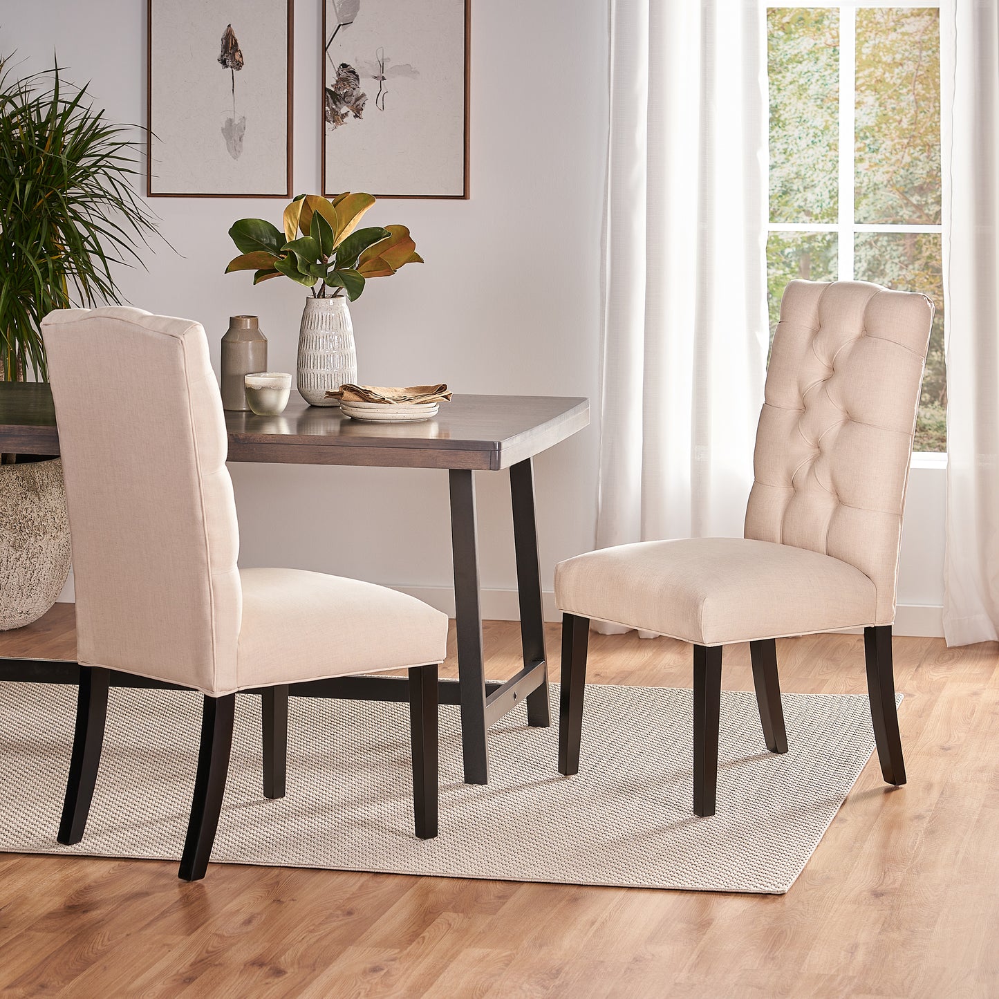 Tufted beige fabric dining chair with diamond stitching and dark wood legs