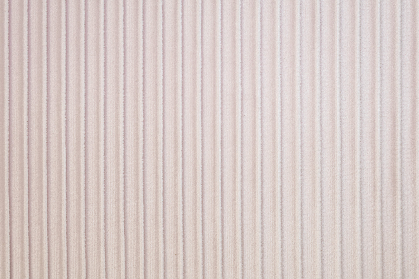 Soft pink velvet fabric with subtle vertical ribbing perfect for upholstery projects