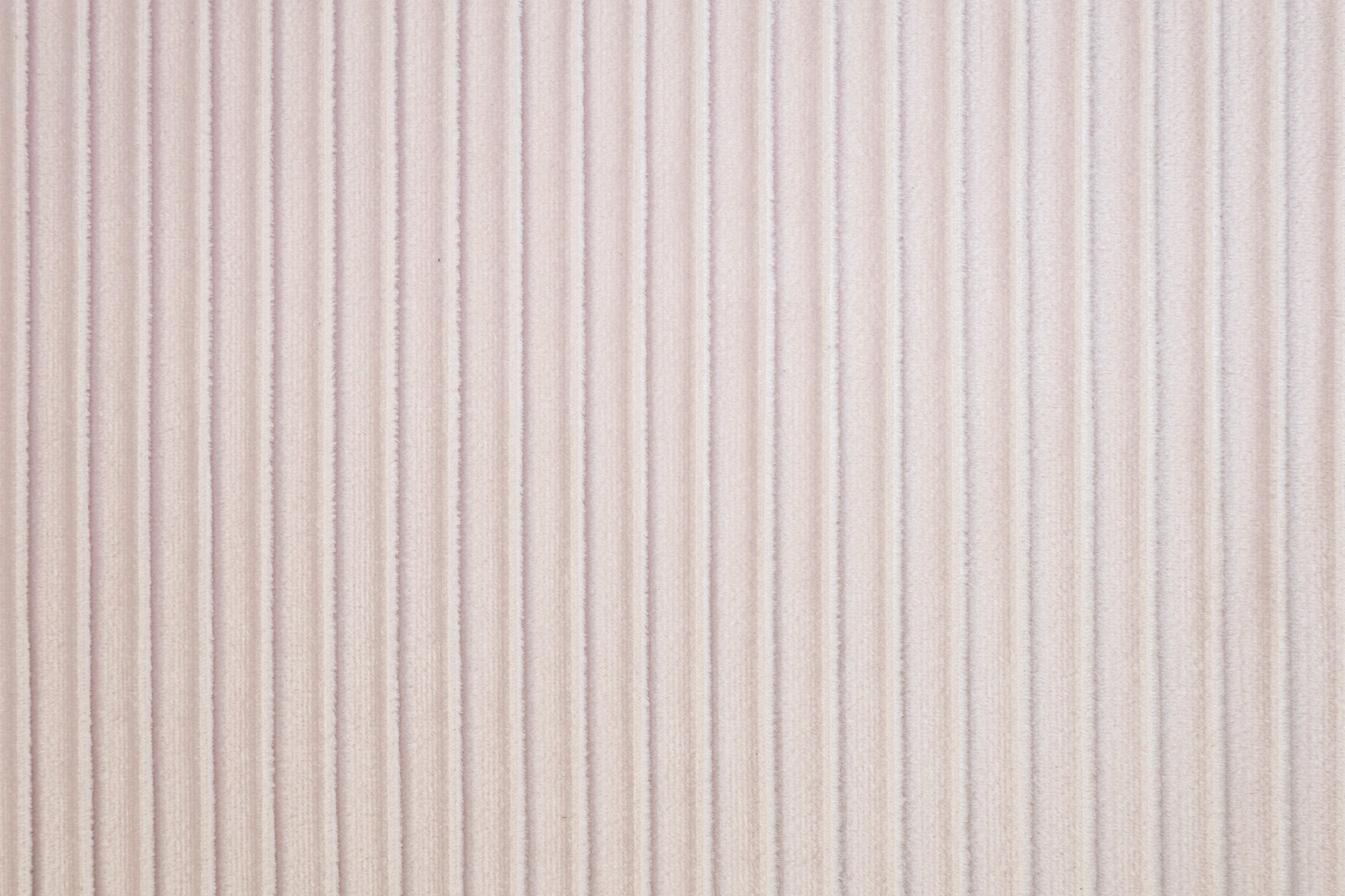 Soft pink velvet fabric with subtle vertical ribbing perfect for upholstery projects