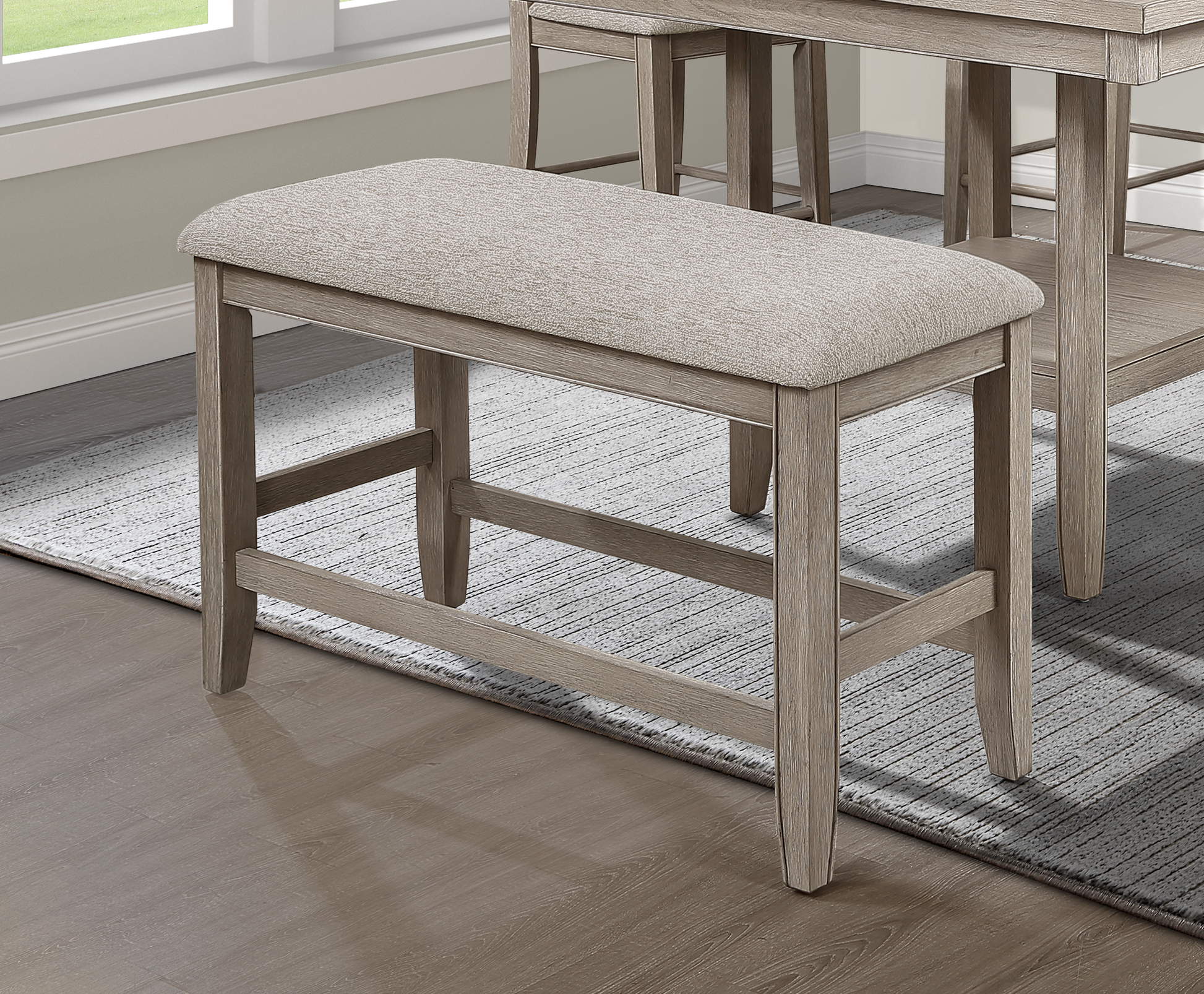 Light brown fabric upholstered counter stool with a distressed wood frame and slender legs
