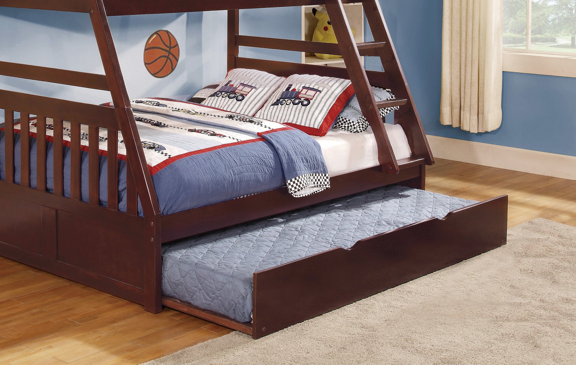 Wooden triple bunk bed with pullout trundle and trainthemed bedding for kids