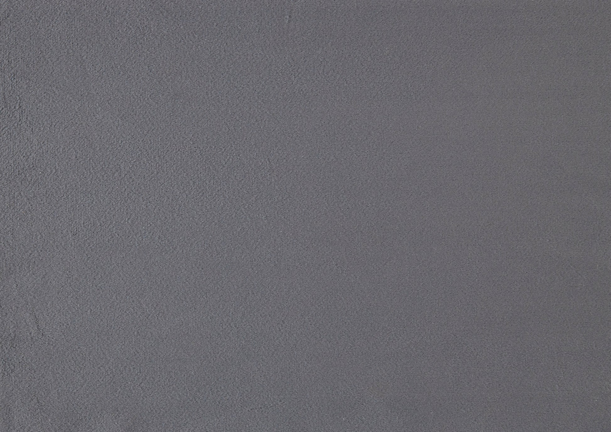 Closeup textured shot of a dark grey felt fabric with a fine fuzzy nap for crafting