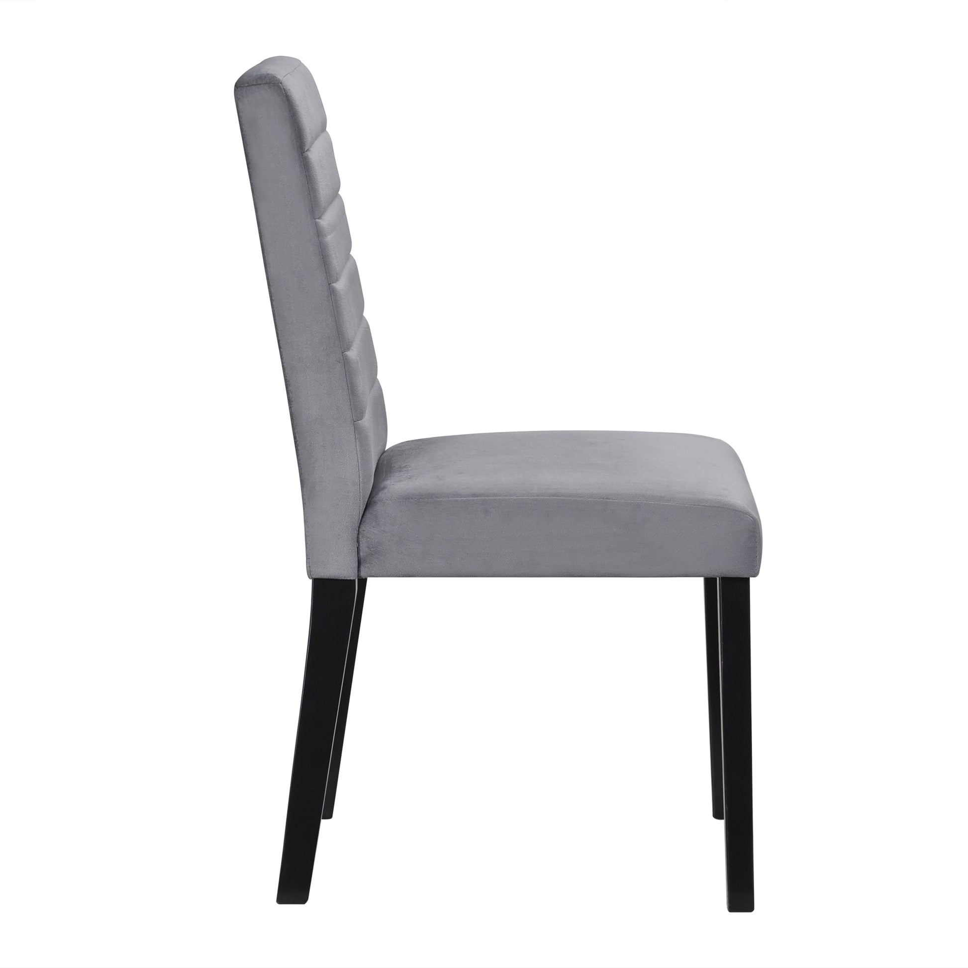 Side view of a plush grey velvet dining chair with black tapered legs and channel tufted back