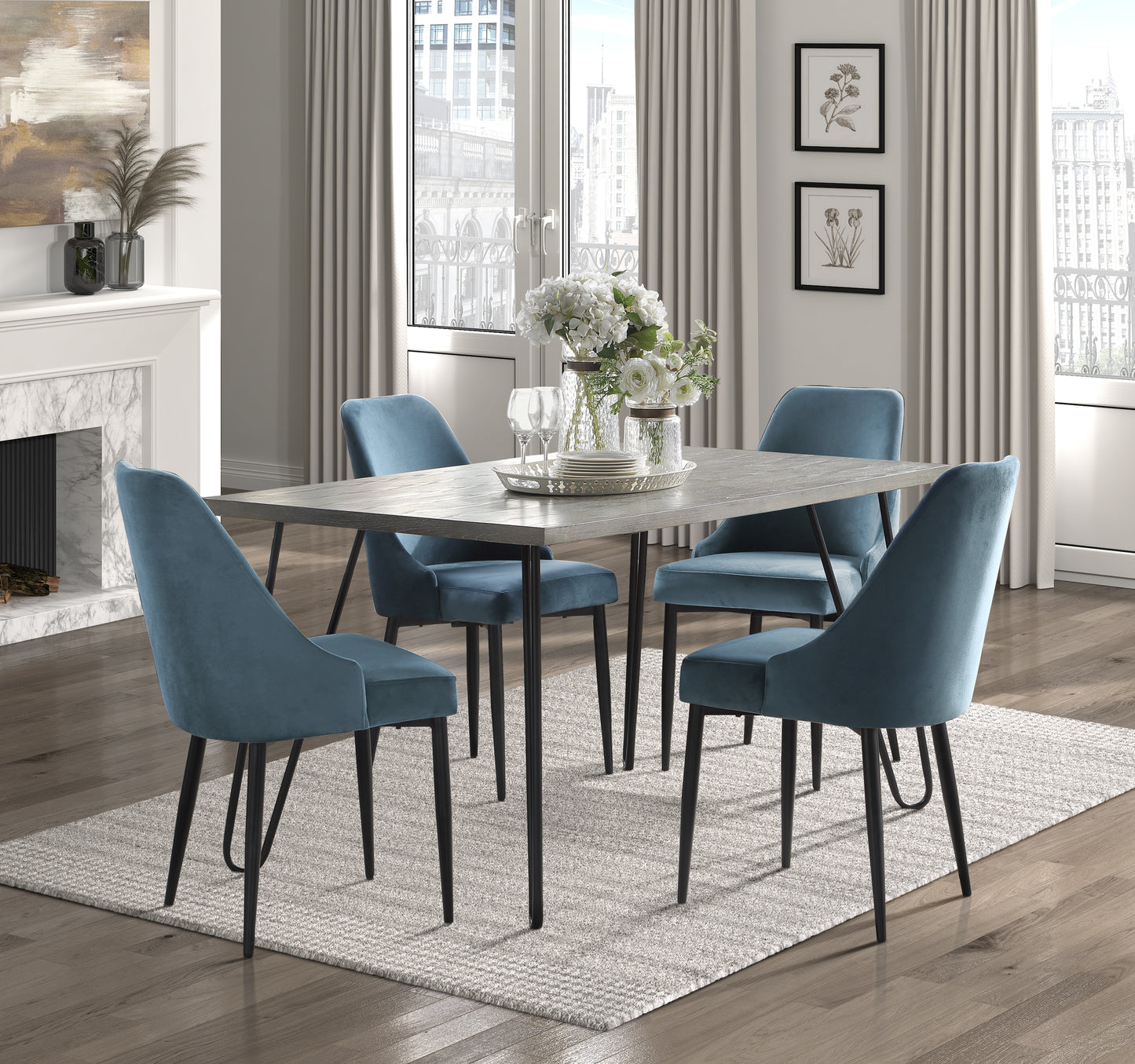 Modern dining set with distressed gray wood table and four blue velvet chairs