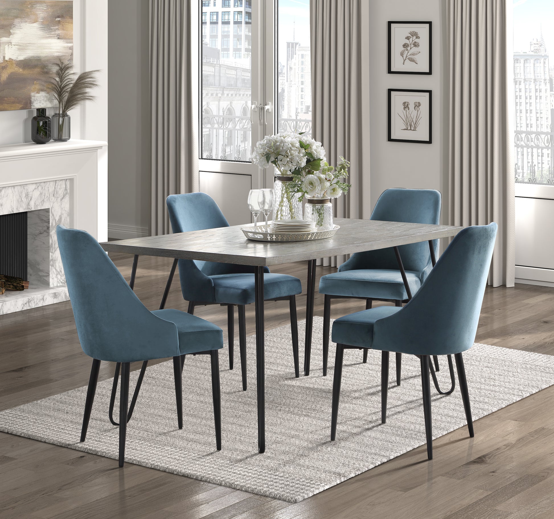 Modern dining set with distressed gray wood table and four blue velvet chairs