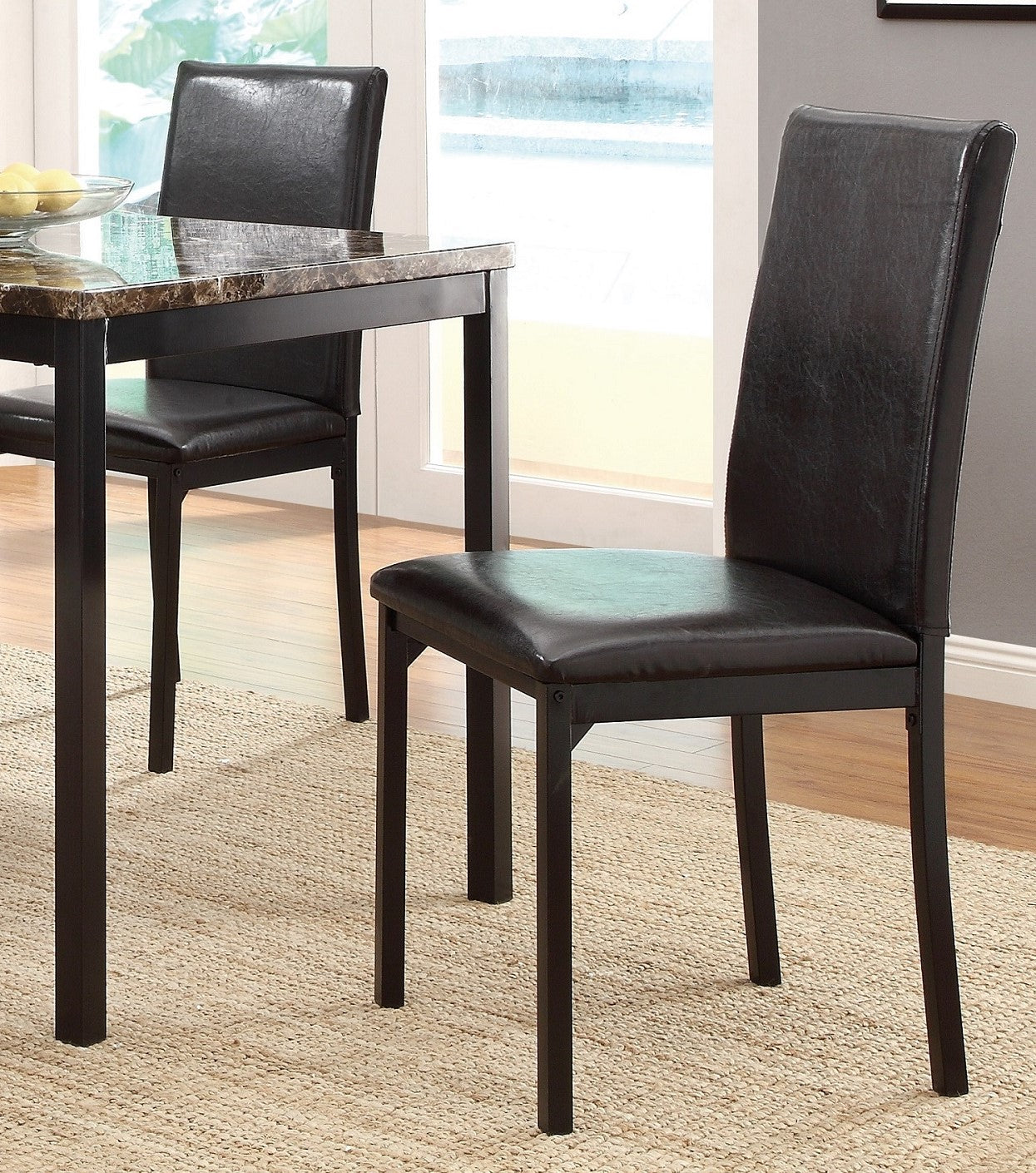 Black faux leather dining chair with dark metal frame