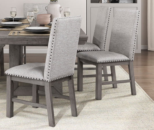 Grey upholstered dining chair with nailhead trim and distressed wood legs