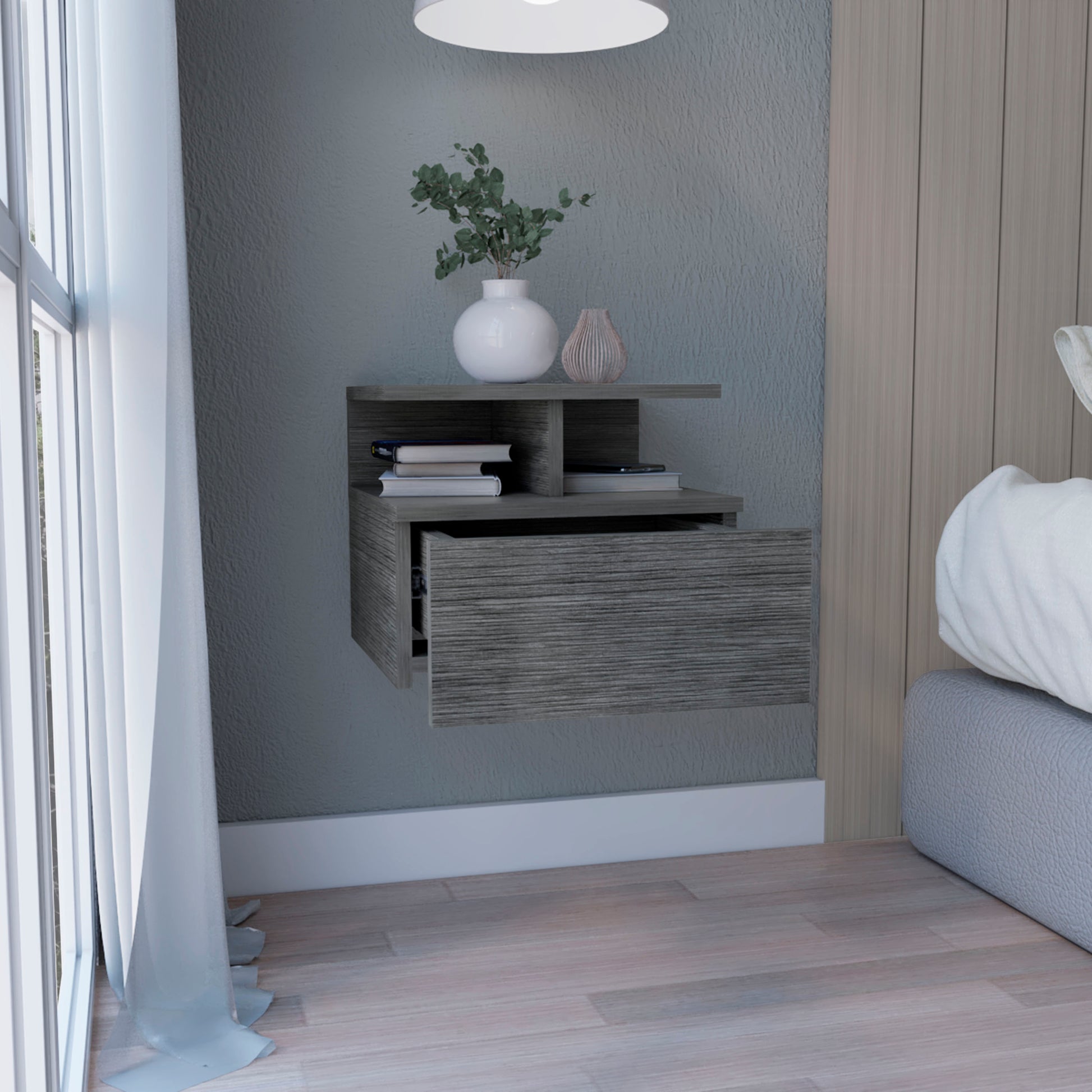 Gray wood floating nightstand with open drawer and books