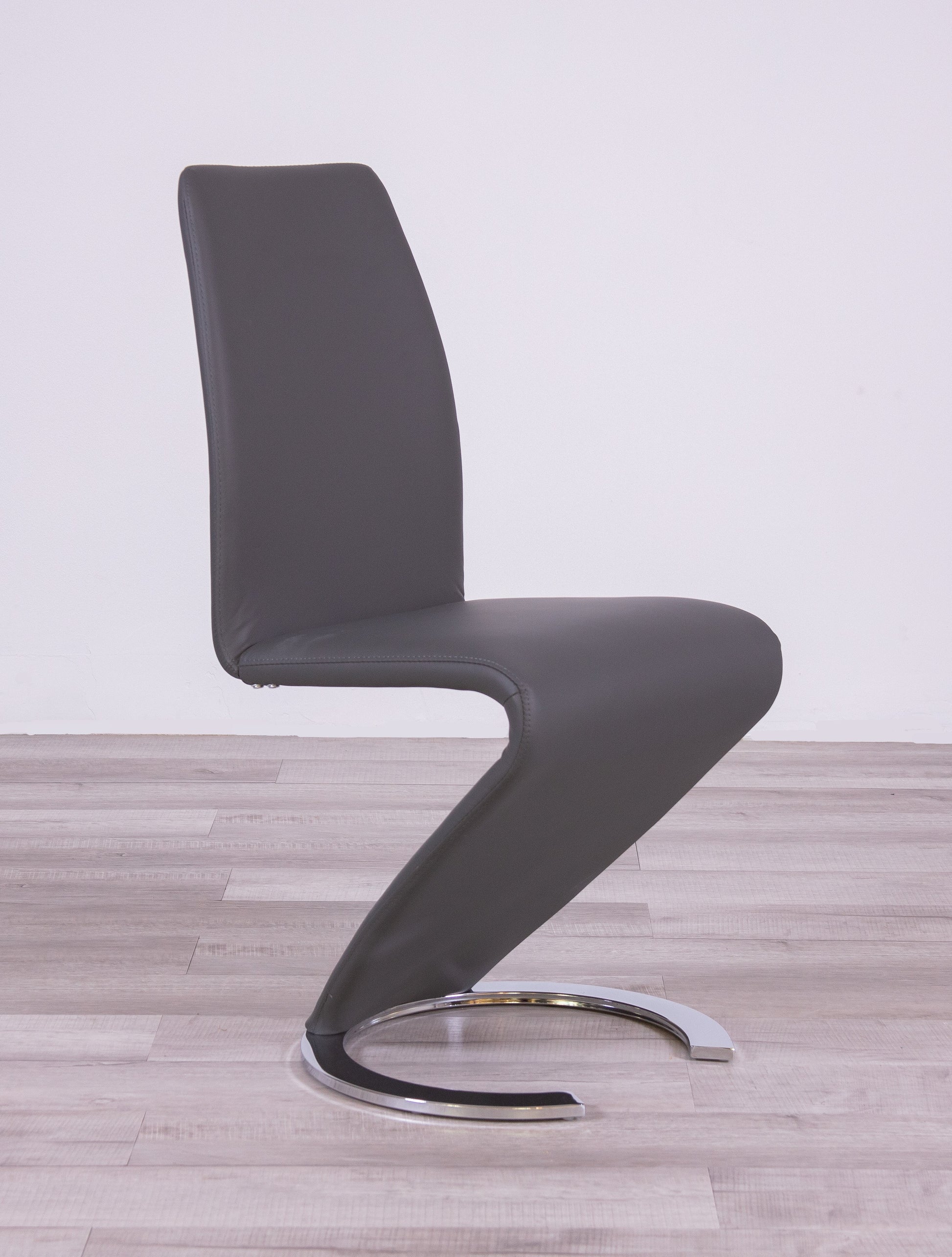 Modern grey faux leather dining chair with chrome cantilever base