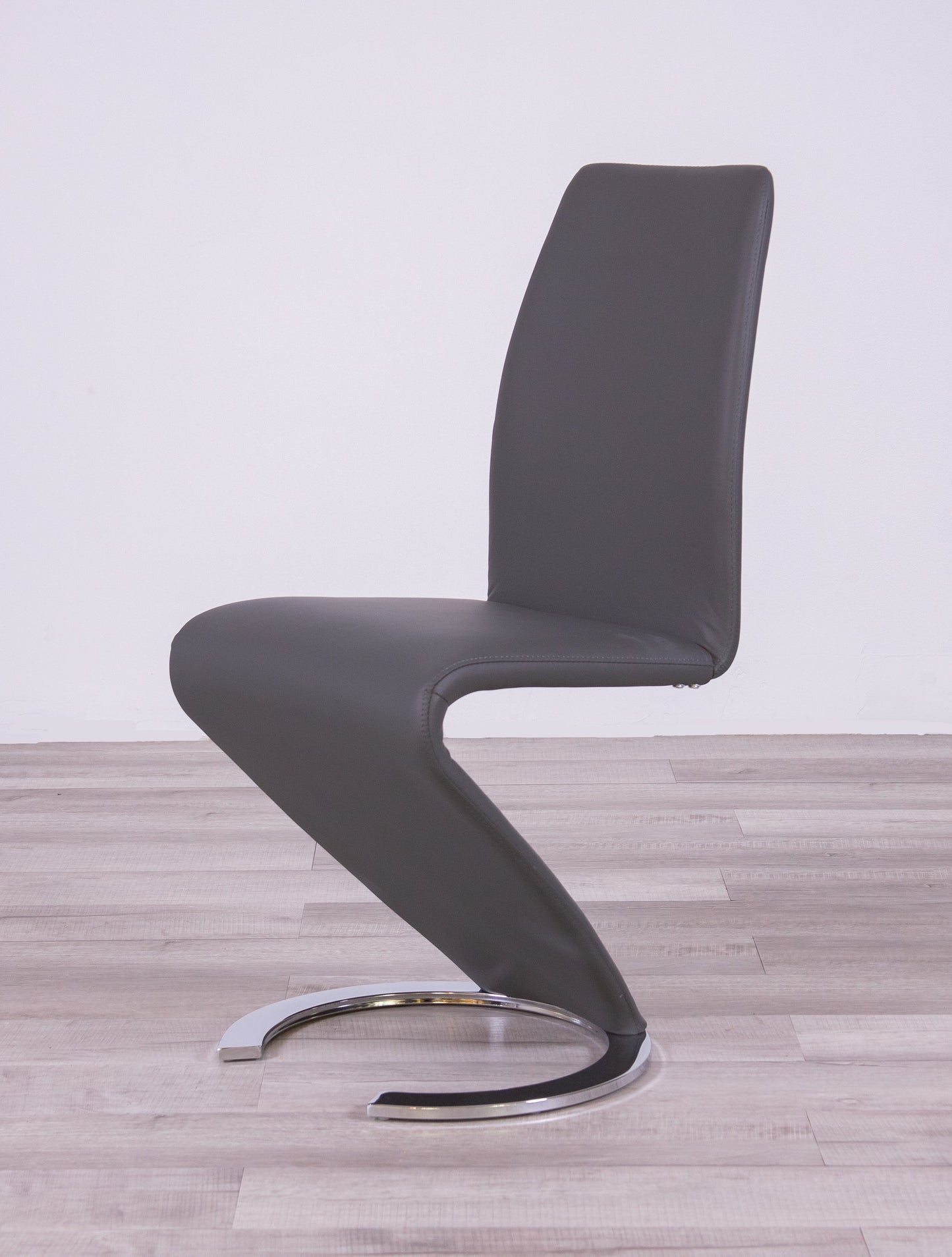 Gray faux leather cantilever dining chair with chrome base
