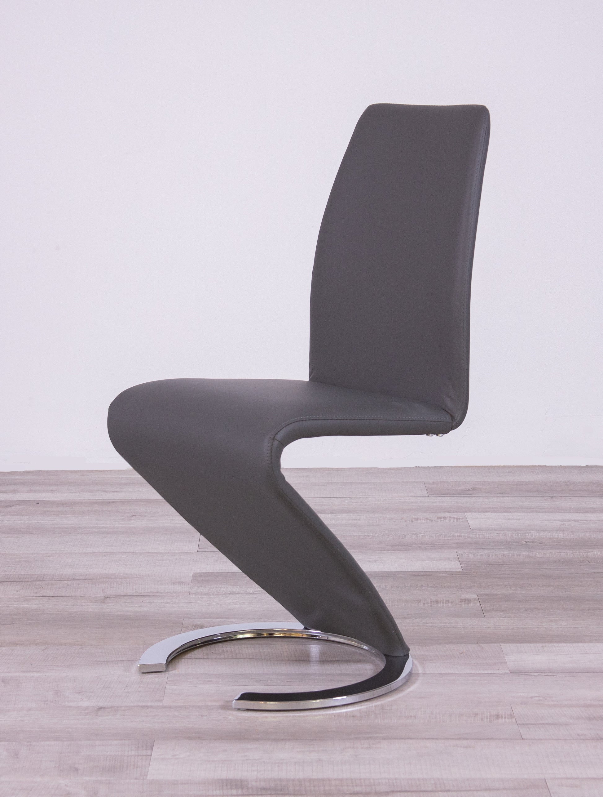 Gray faux leather cantilever dining chair with chrome base