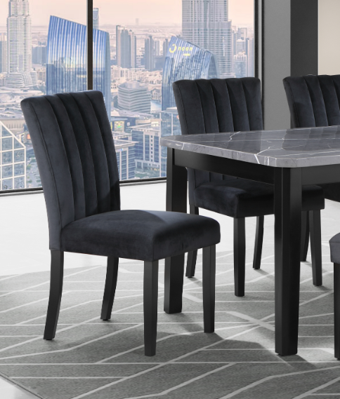 Plush black velvet dining chair with vertical channel tufting on the backrest