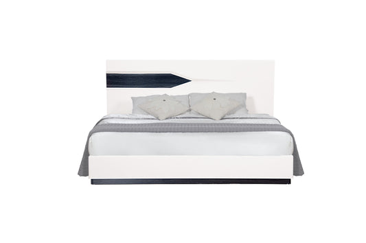 Modern white platform bed frame with dark wood accent and grey bedding