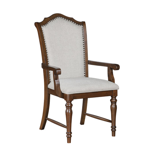 Upholstered dining arm chair with nailhead trim and turned legs