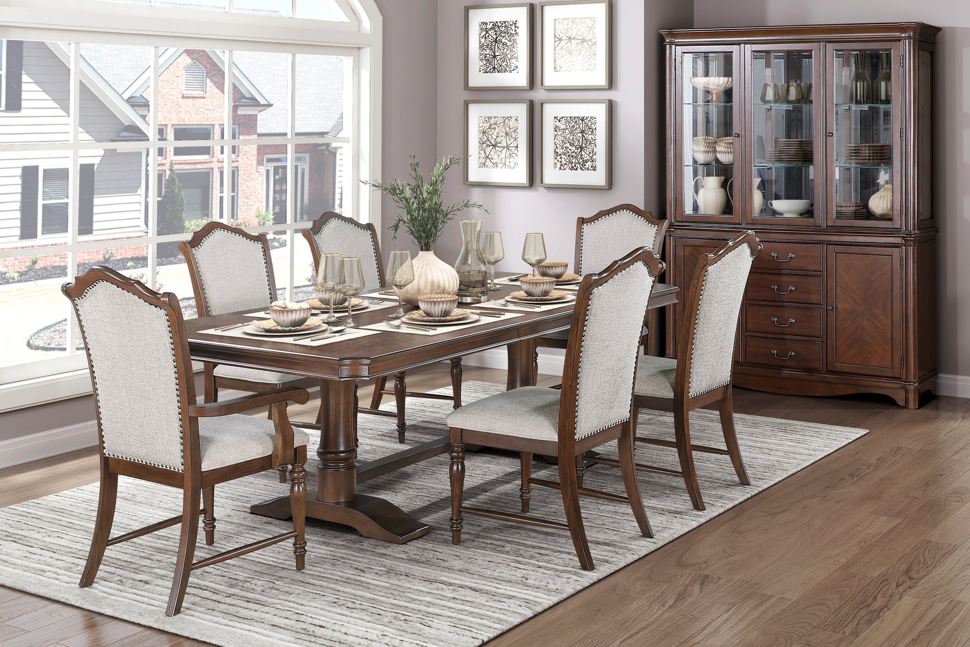 Dark cherry wood dining table set with upholstered chairs and decorative hutch