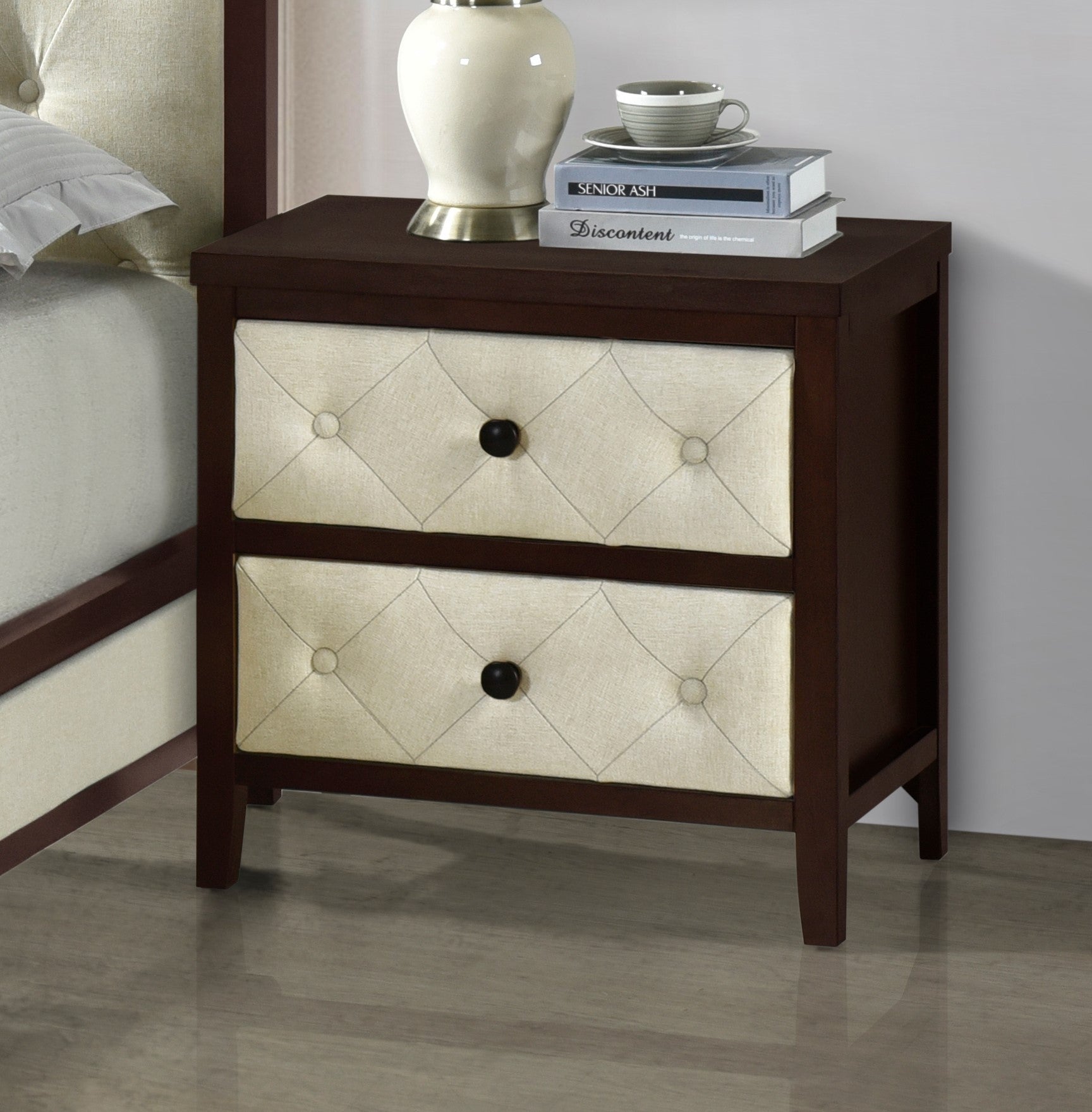 Dark wood bedside table with two tufted beige fabric drawers and black knobs