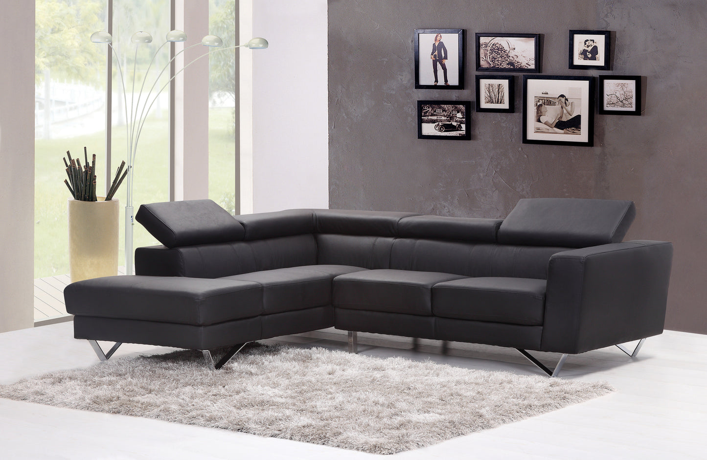 Dark charcoal leather Lshaped sectional sofa with adjustable headrests and chrome legs