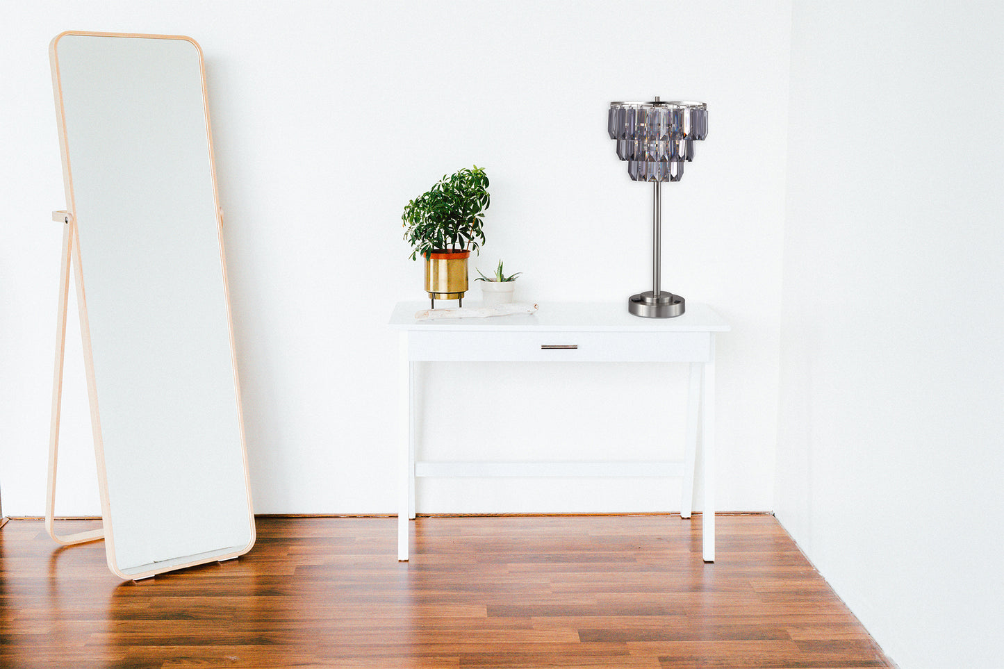 Tall woodframed floor mirror leaning against a white wall perfect for dressing areas