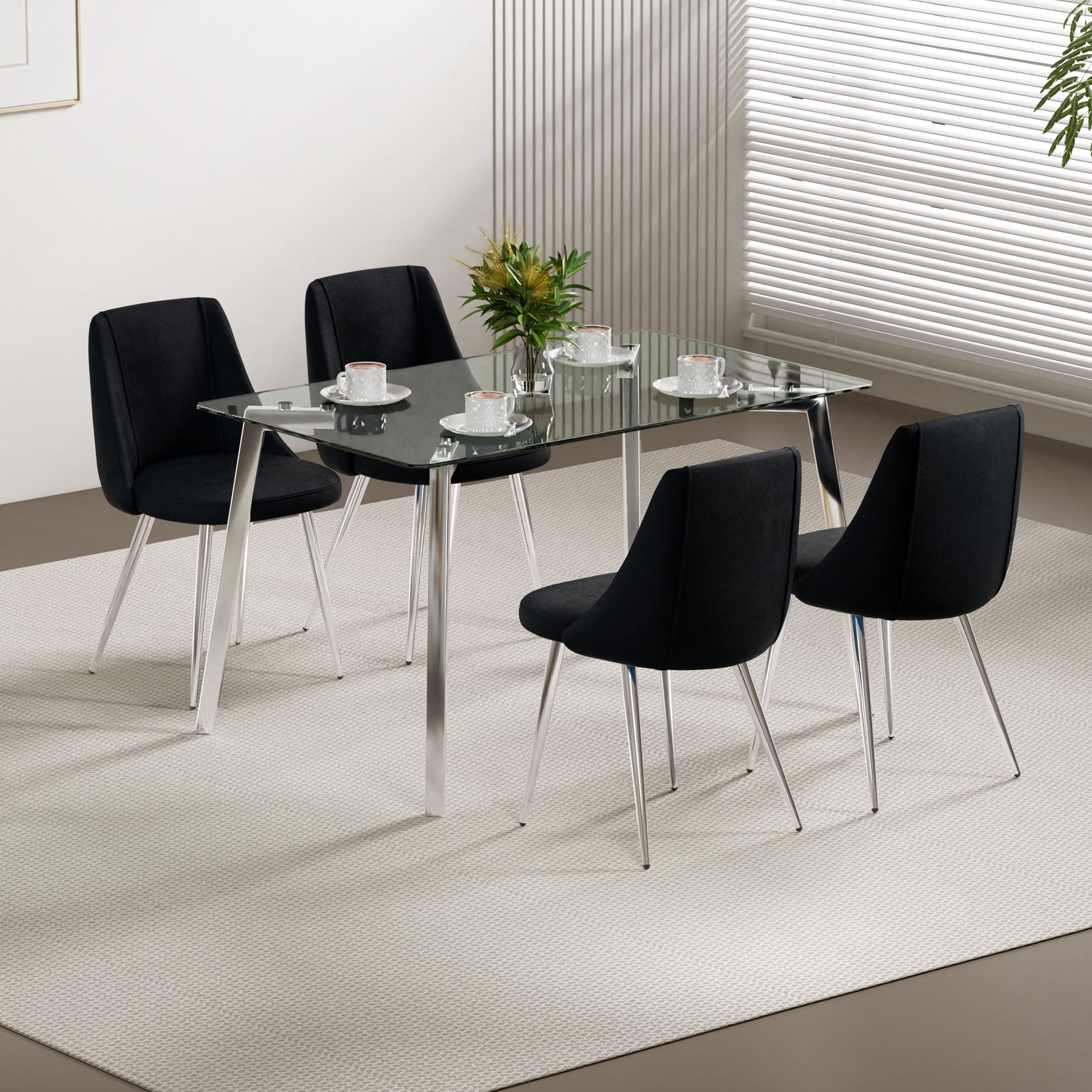 Modern black upholstered dining chairs with chrome legs surrounding a clear glass top dining table