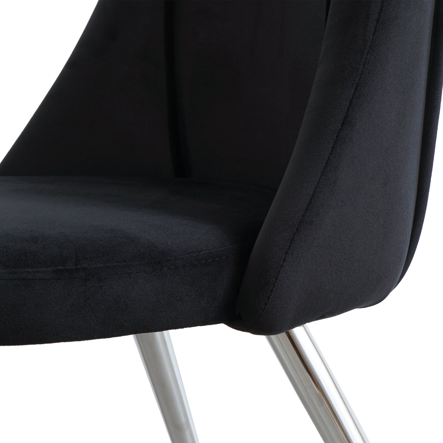 Closeup of a plush black velvet chair seat with stitched detailing and polished chrome legs