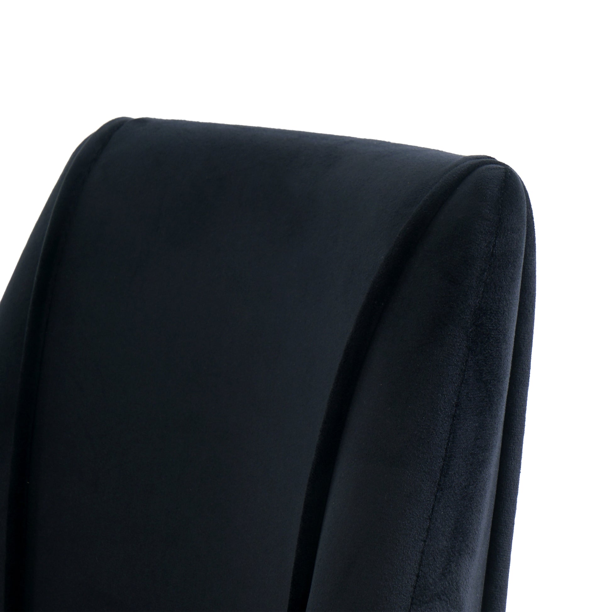 Close up of a plush navy velvet accent chair back with elegant curves