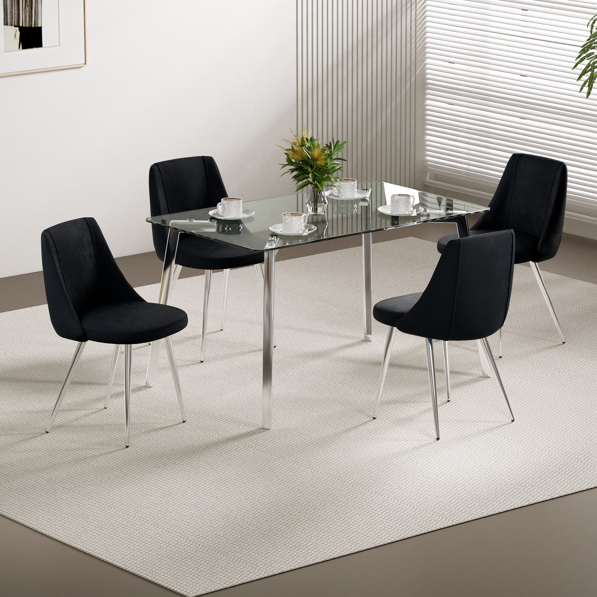 Set of four black upholstered dining chairs with chrome legs