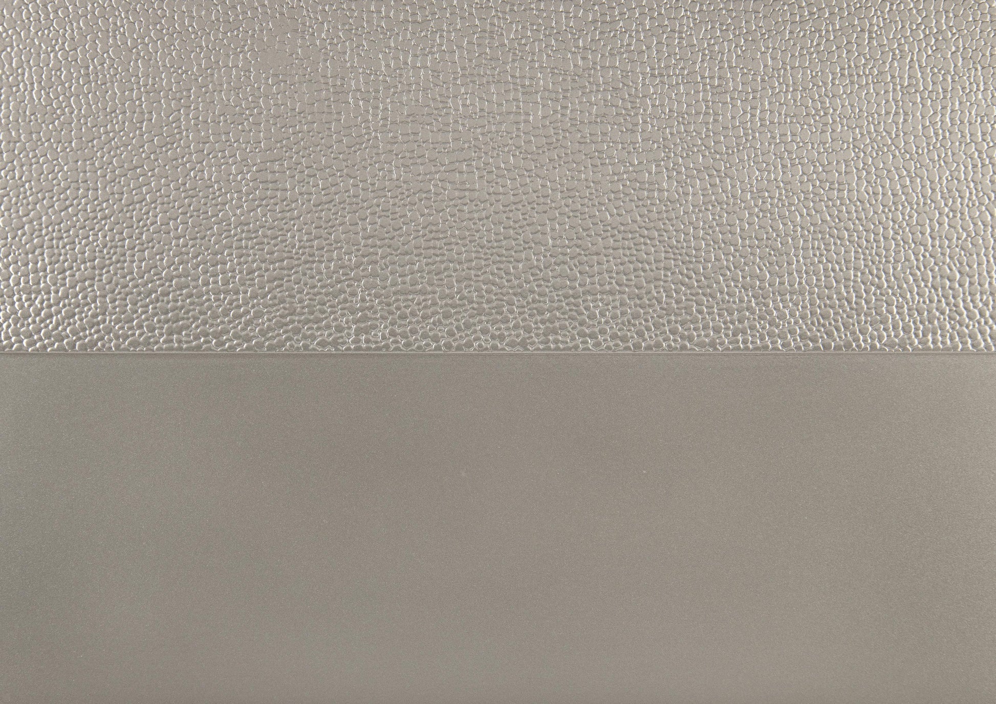 Textured brushed silver metallic finish on a cabinet door panel