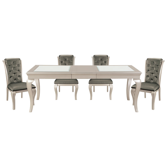 Ornate dining set with tufted gray chairs and a silverfinished table with glass inlays