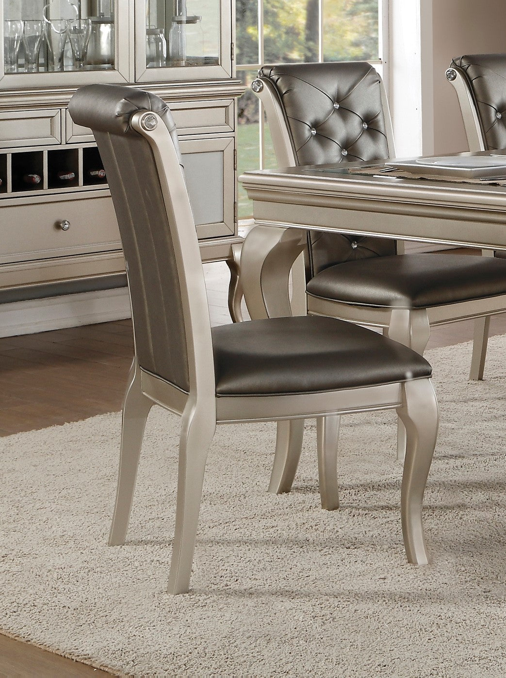 Champagne dining chair with dark gray upholstered seat and back