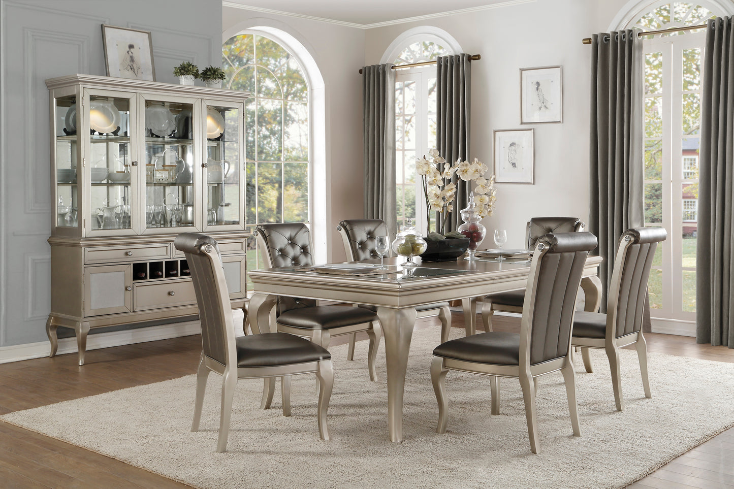 Elegant silver dining set with a glasstop table and upholstered chairs perfect for formal dining