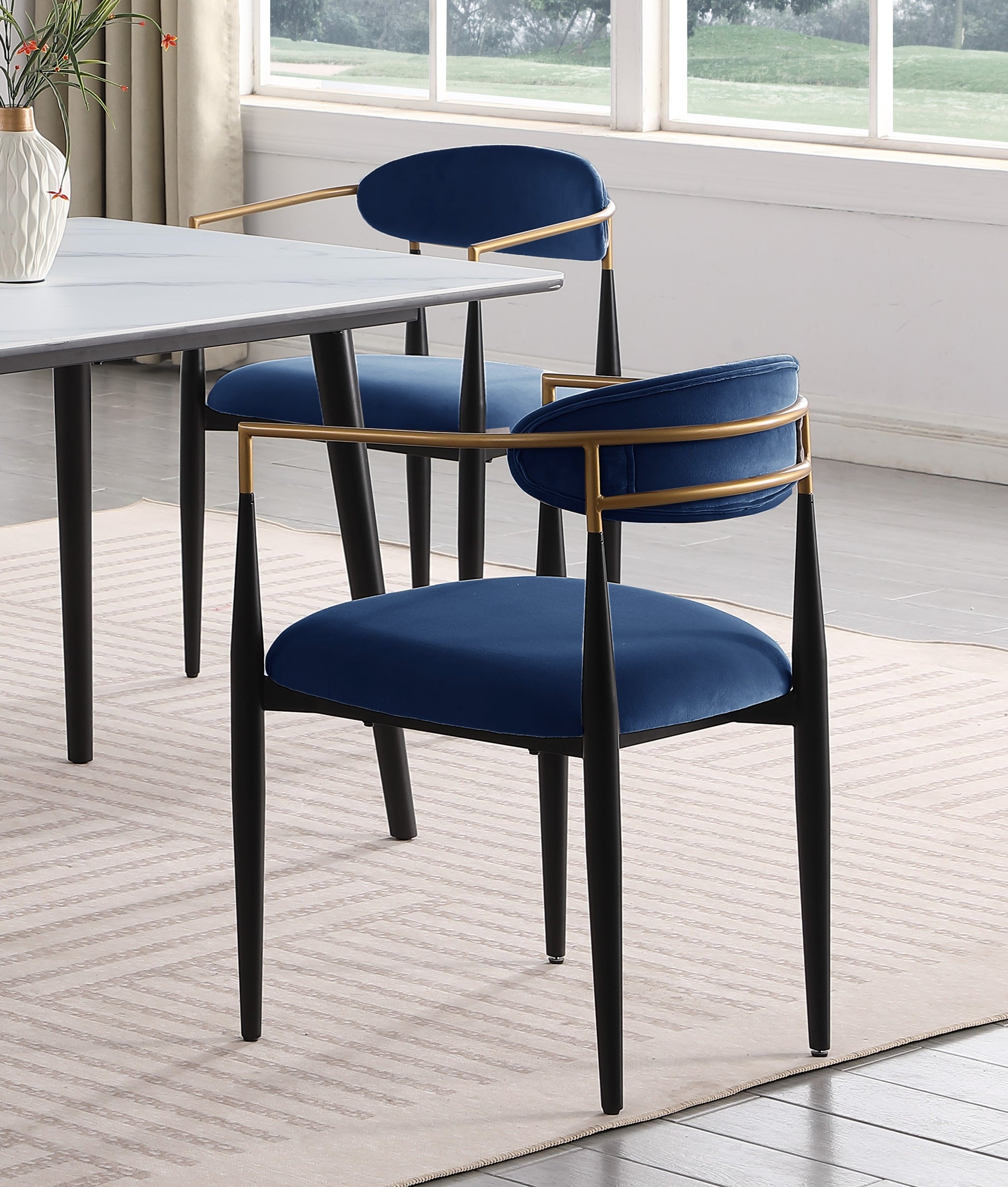Elegant navy blue velvet dining chair with gold frame and black tapered legs