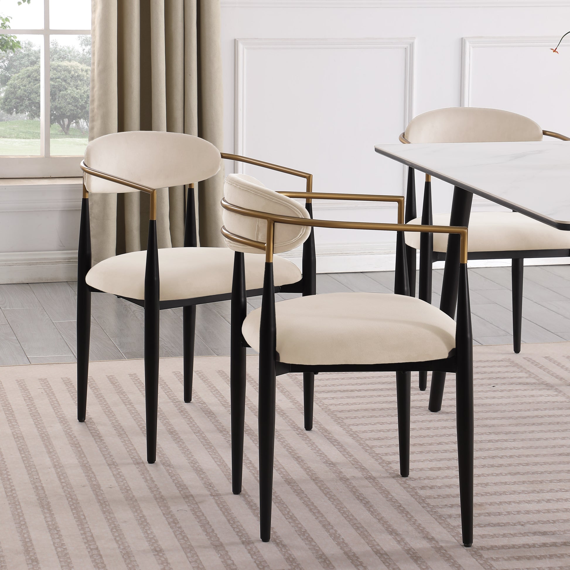 Elegant cream velvet dining chair with gold metal frame and black tapered legs