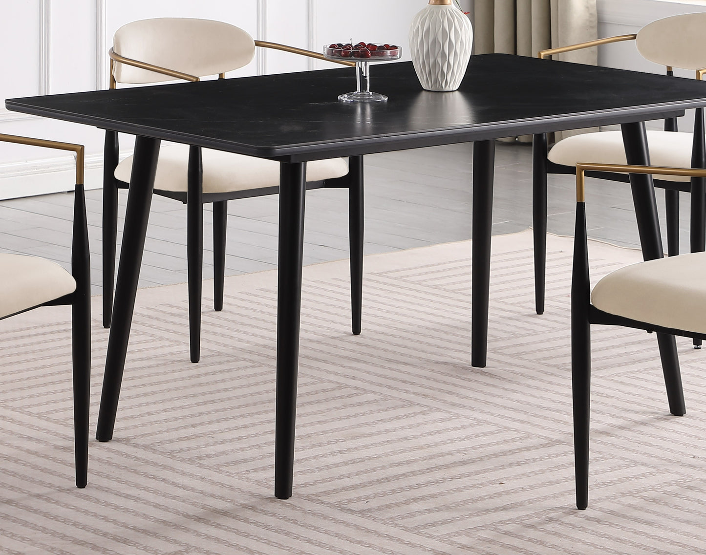 Modern black marble dining table with cream upholstered chairs and gold accents