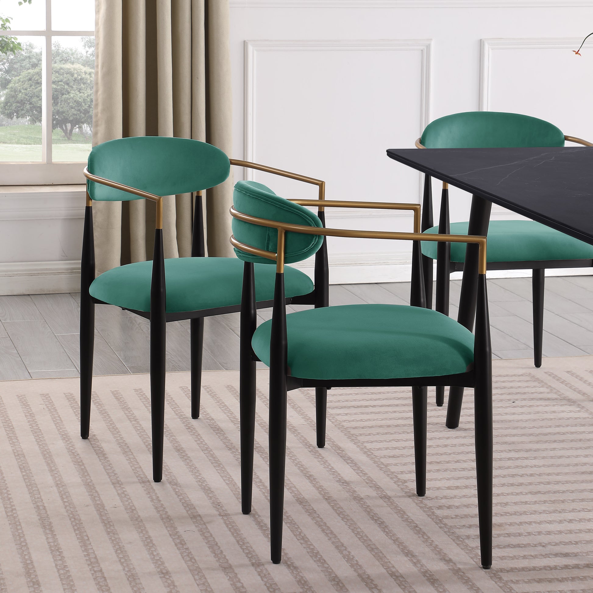 Elegant teal velvet dining chair with gold accents and black legs