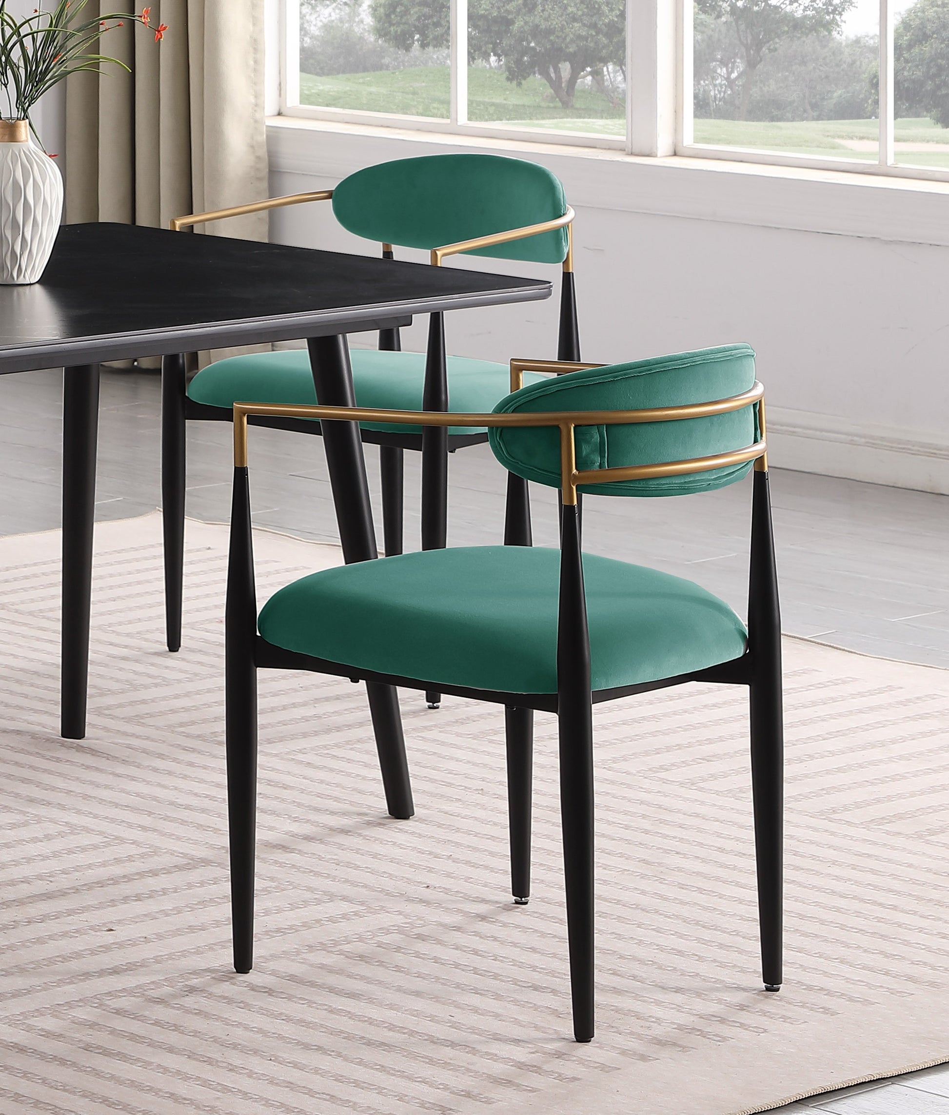 Emerald velvet accent chair with gold metal frame and black legs