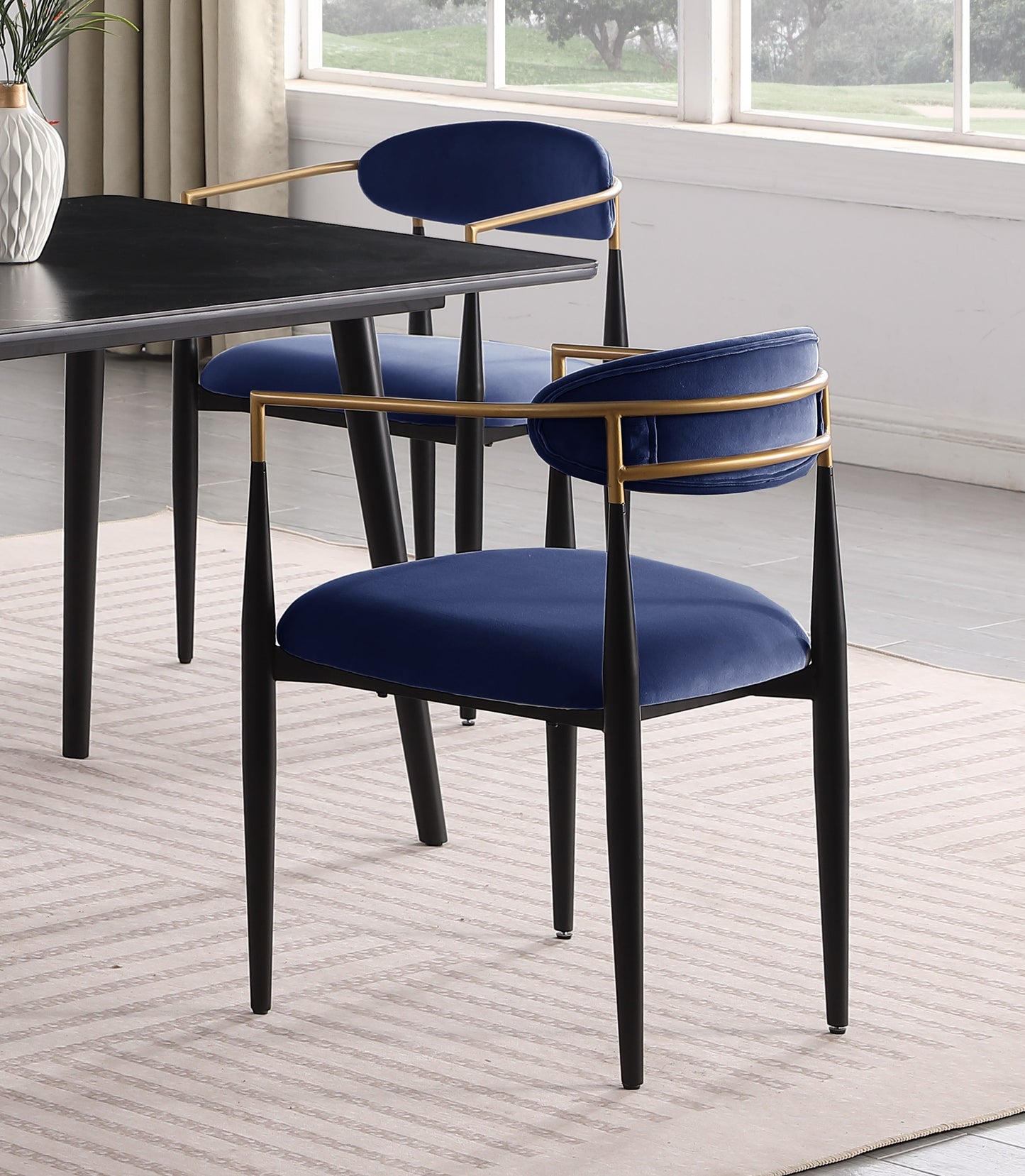 Elegant navy velvet dining chair with gold accents and black legs
