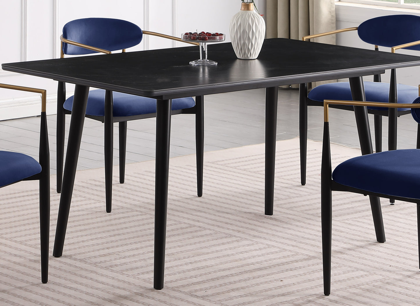 Black rectangular dining table with curved corners and metal legs