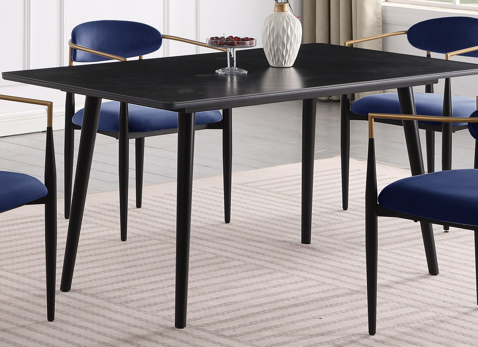 Black rectangular dining table with curved corners and metal legs