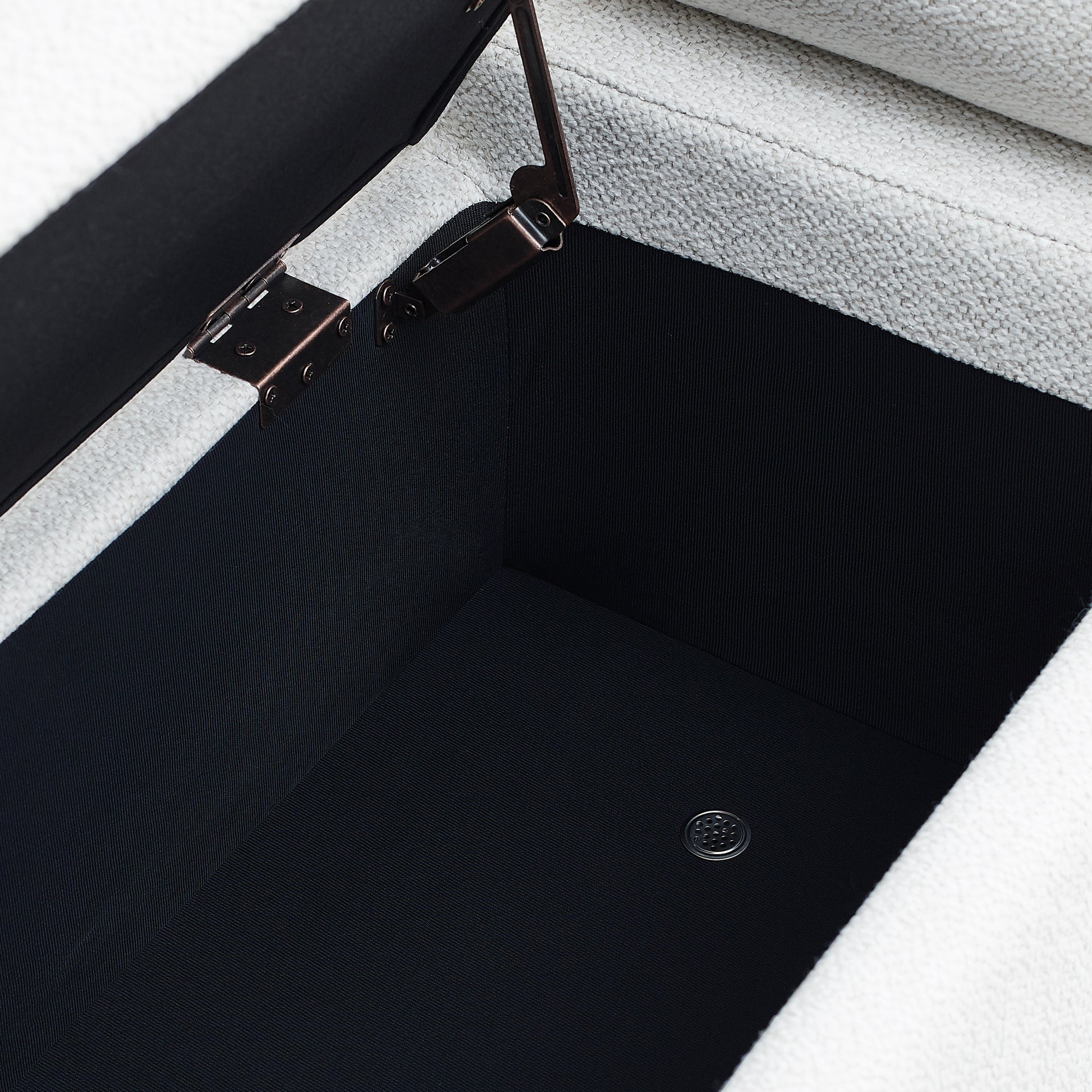 Open ottoman storage with textured light grey fabric and dark grey interior