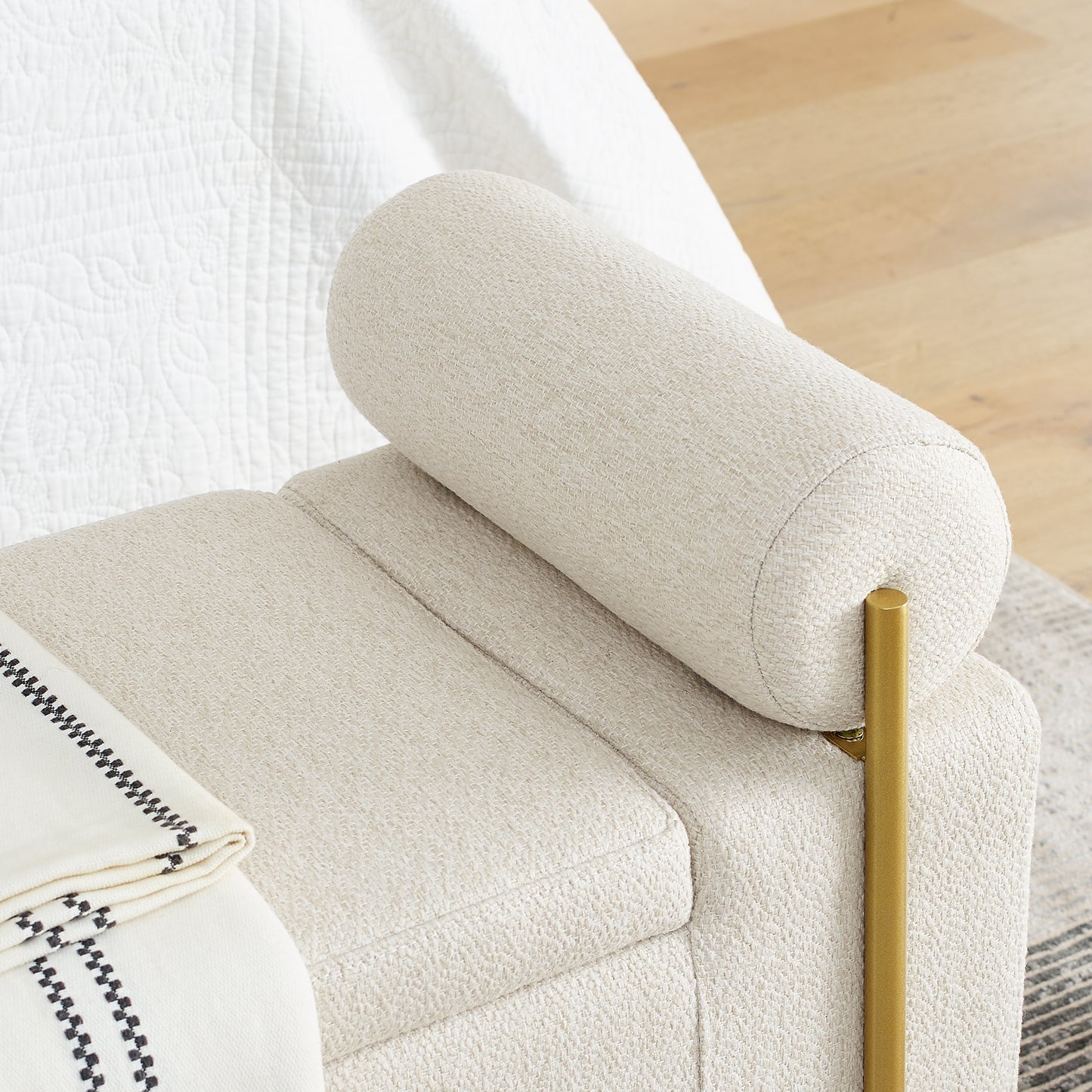Cream boucle armchair with gold leg and rolled bolster pillow