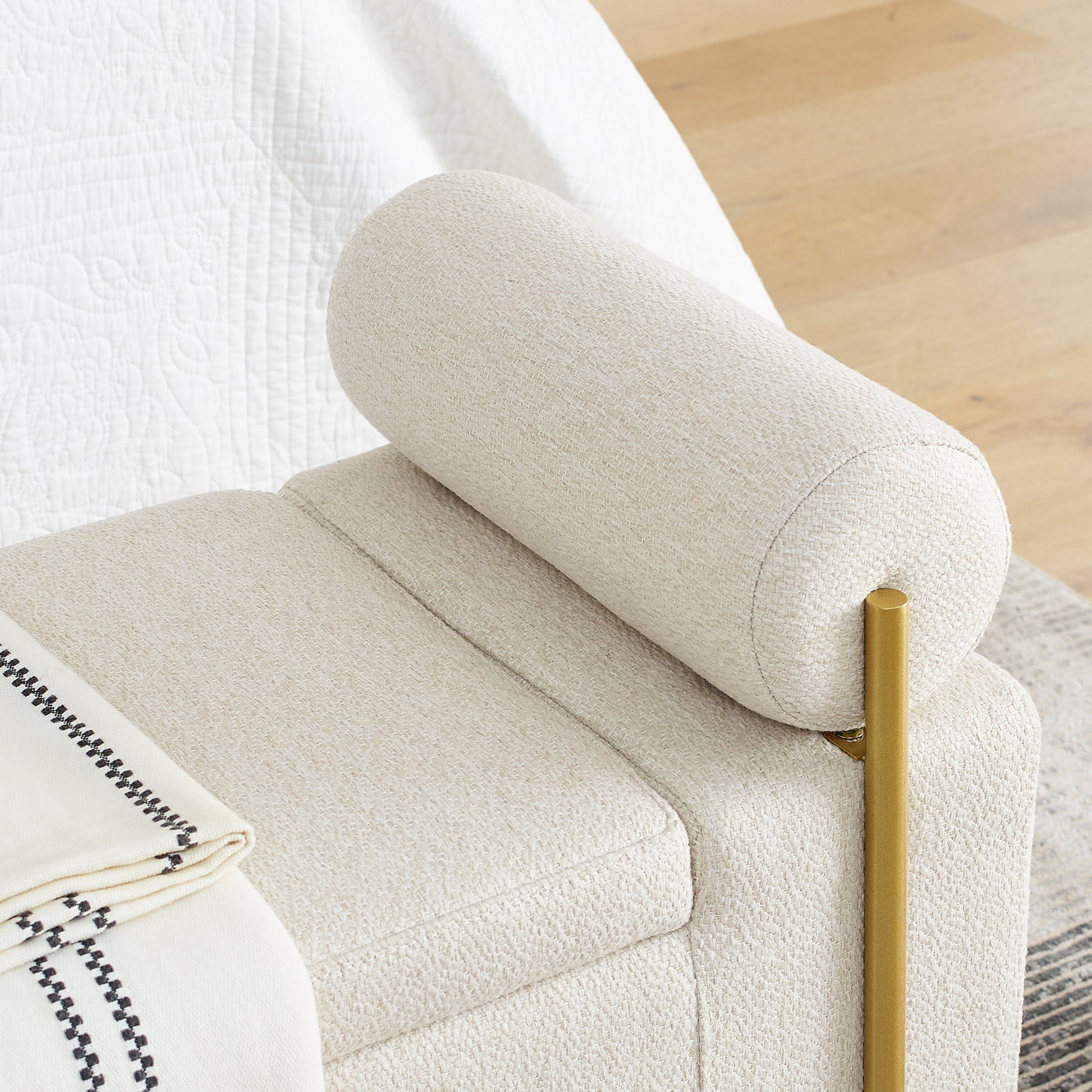 Cream boucle armchair with gold leg and rolled bolster pillow