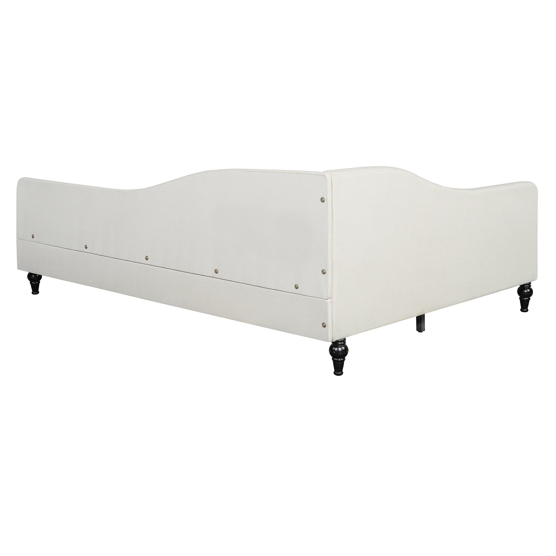 Cream upholstered daybed with curved back and black turned legs