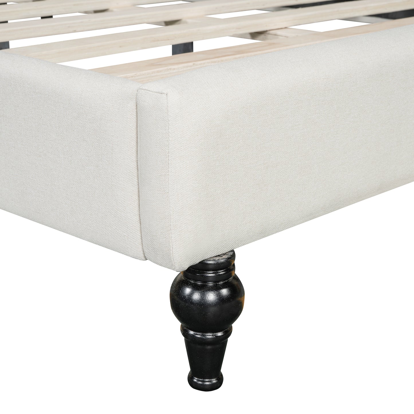 Upholstered bed frame in neutral linen with black wooden carved legs