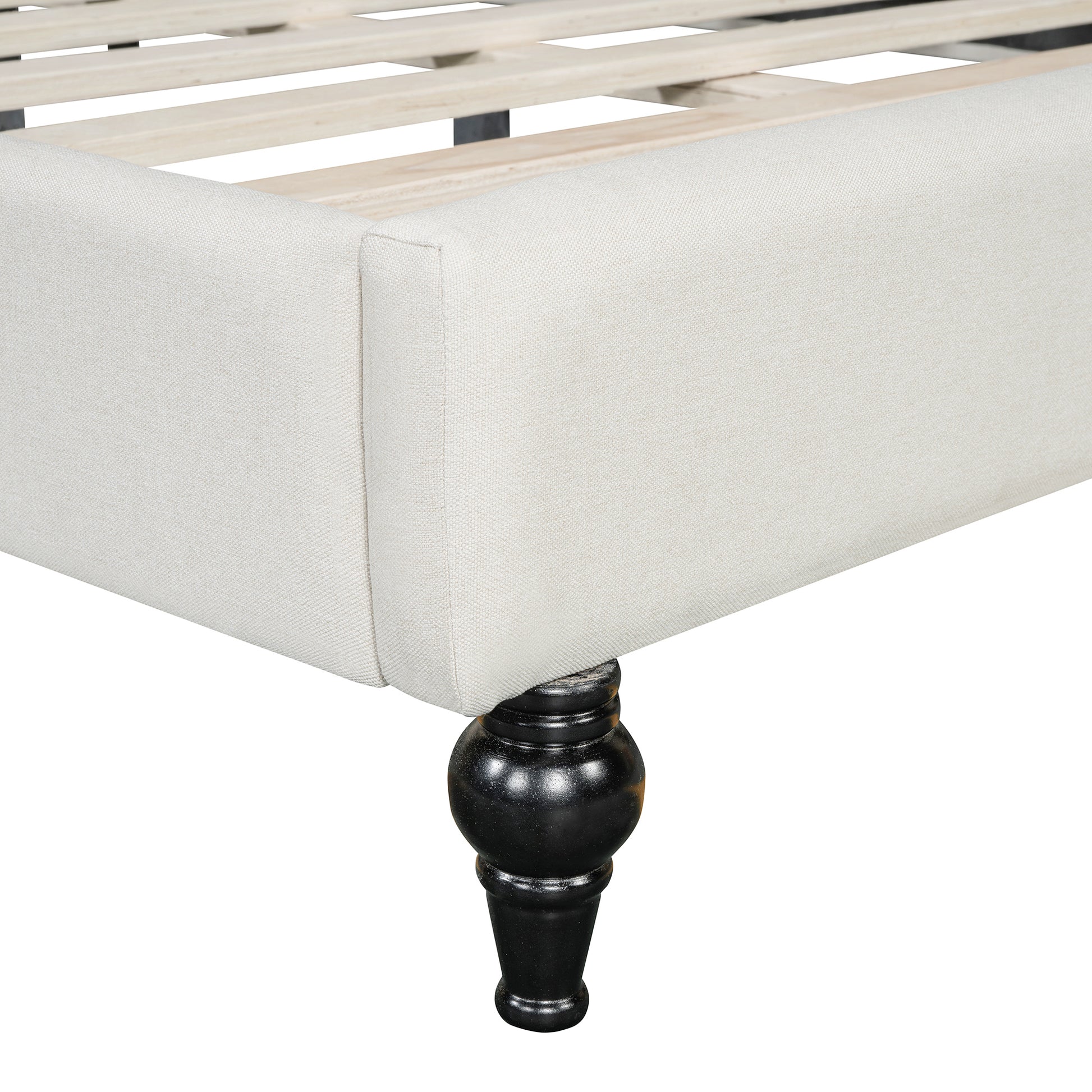 Upholstered bed frame in neutral linen with black wooden carved legs