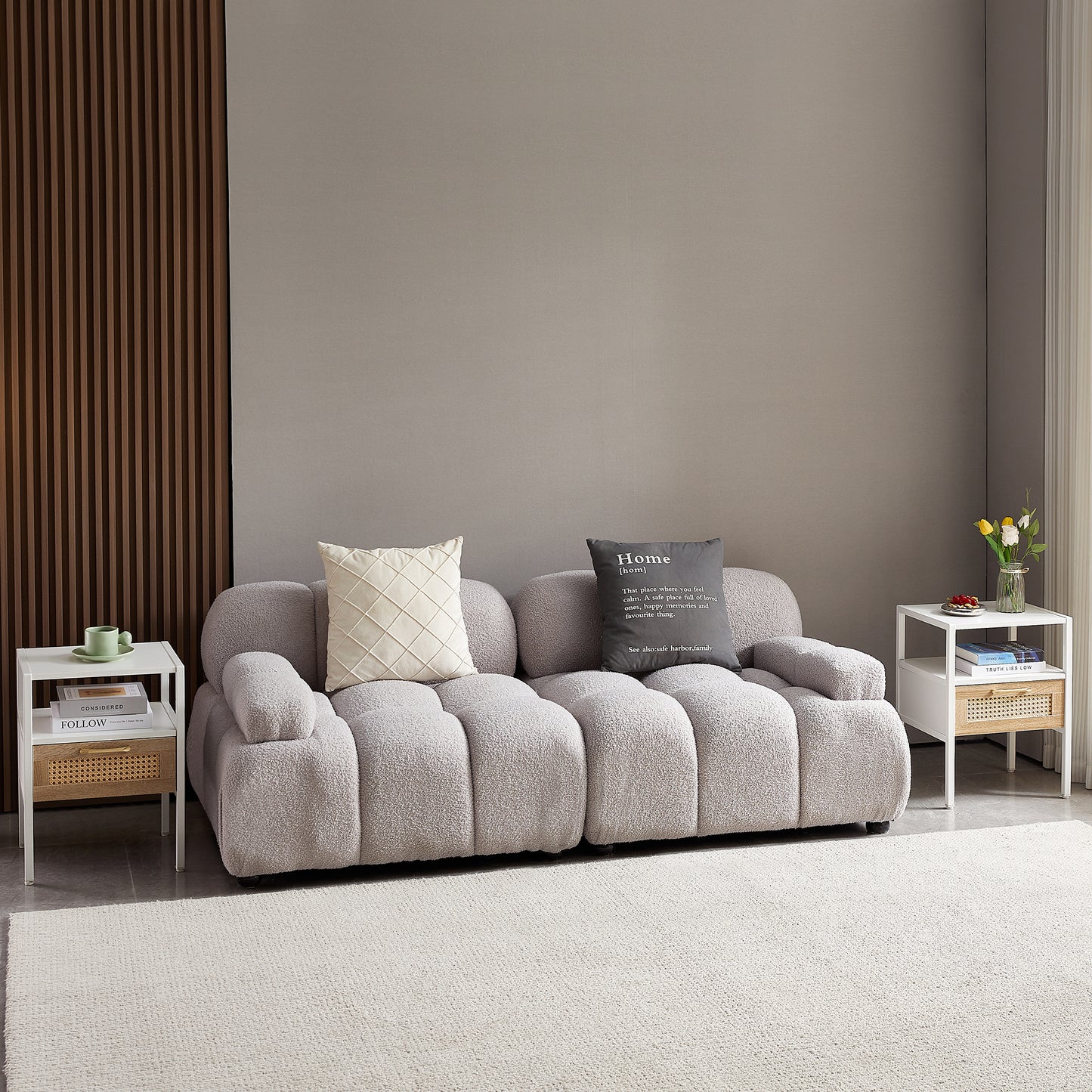Light gray boucle fabric sofa with tufted seating and matching pillows